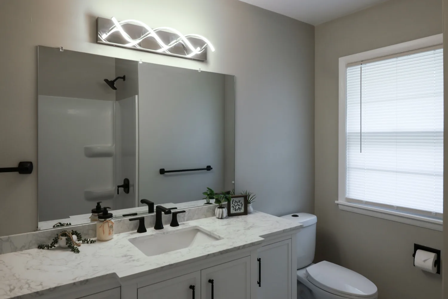 Bathroom interior painting project with soft gray walls and white vanity